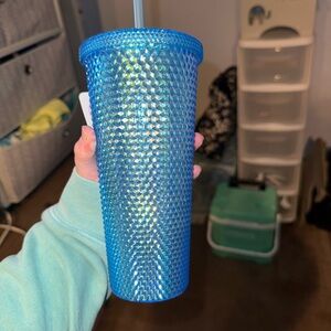 Blue colored water bottle with straw
